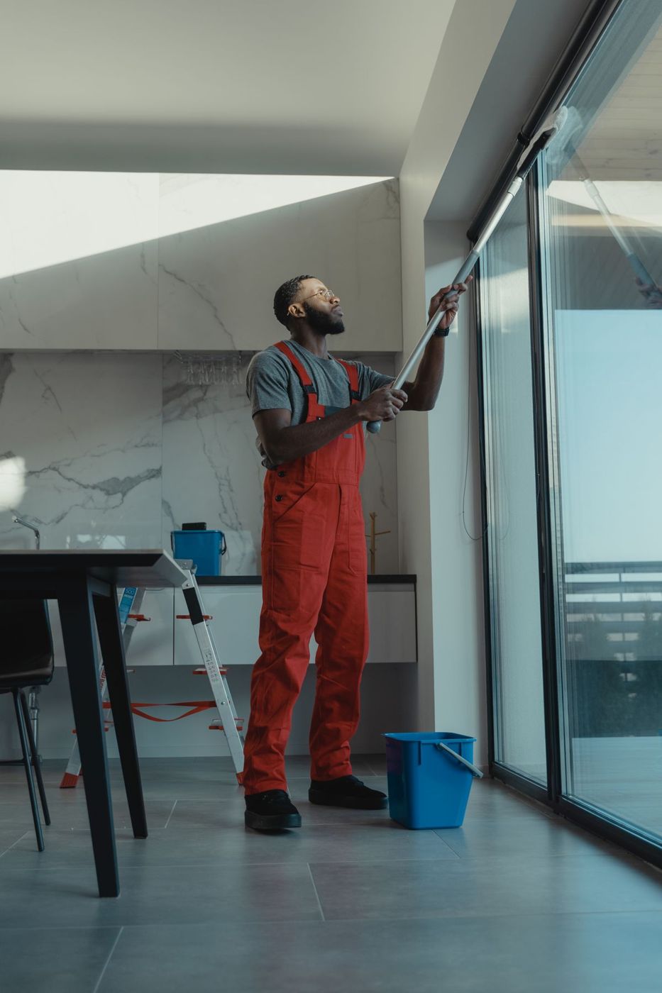 Window cleaner squeegeeing glass in Wellington